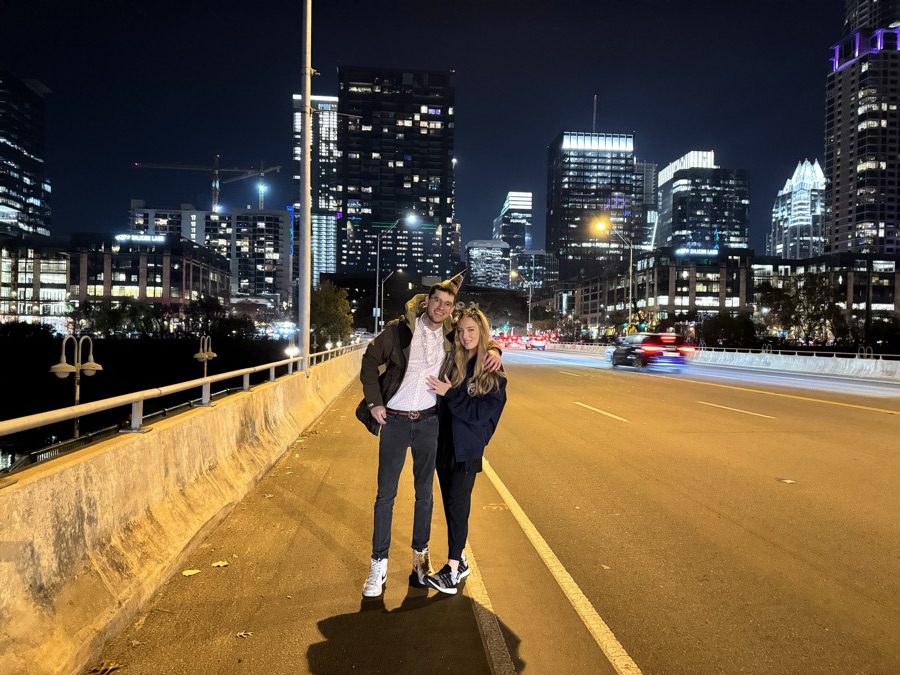 The two of us on the bridge, city lights behind
